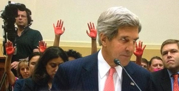 people sitting behind Kerry with bloody hands